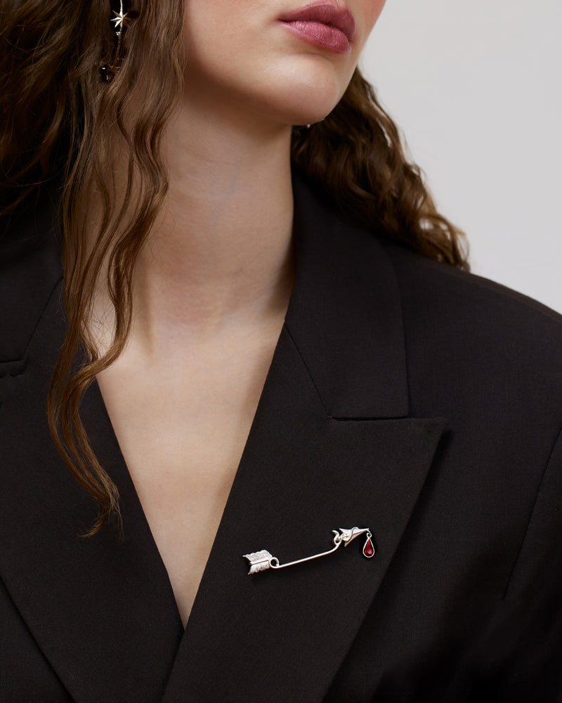 Statement brooch with arrow and dangling garnet drop