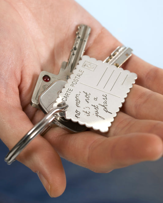No Mom, it's not just a phase key chain Postcard to Home silver-plated in hand