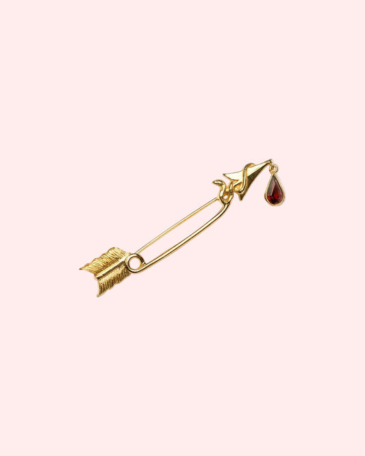 Statement brooch with arrow and dangling garnet drop