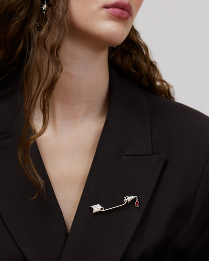 Statement brooch with arrow and dangling garnet drop